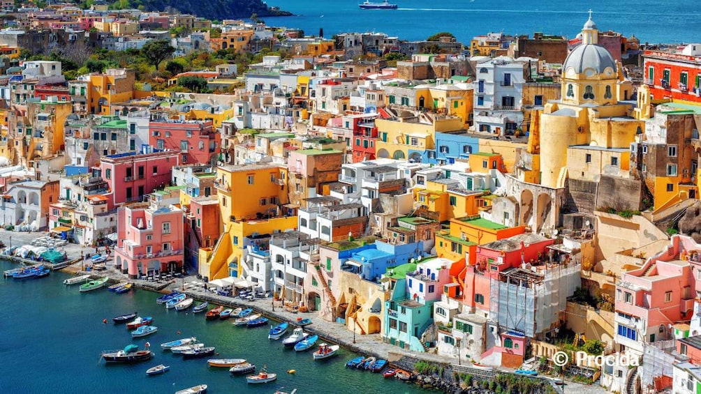A coastal town with colorful buildings and boats docked along the waterfront. 1