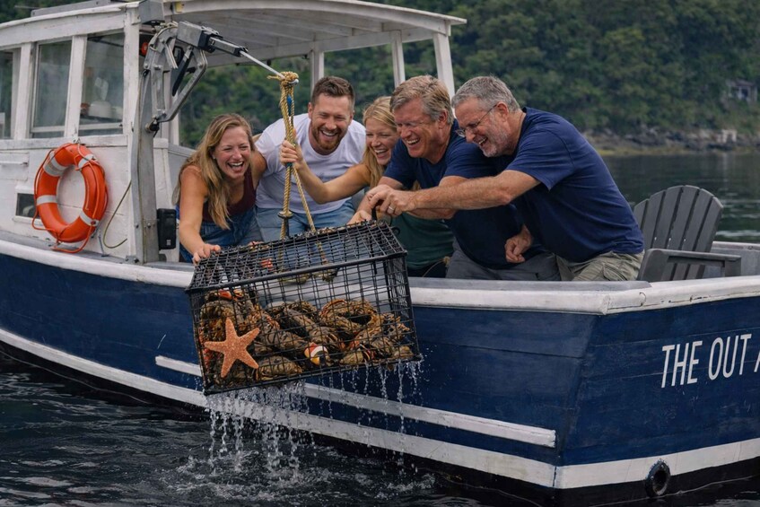 A group of people on a boat with a lobster trap. 1