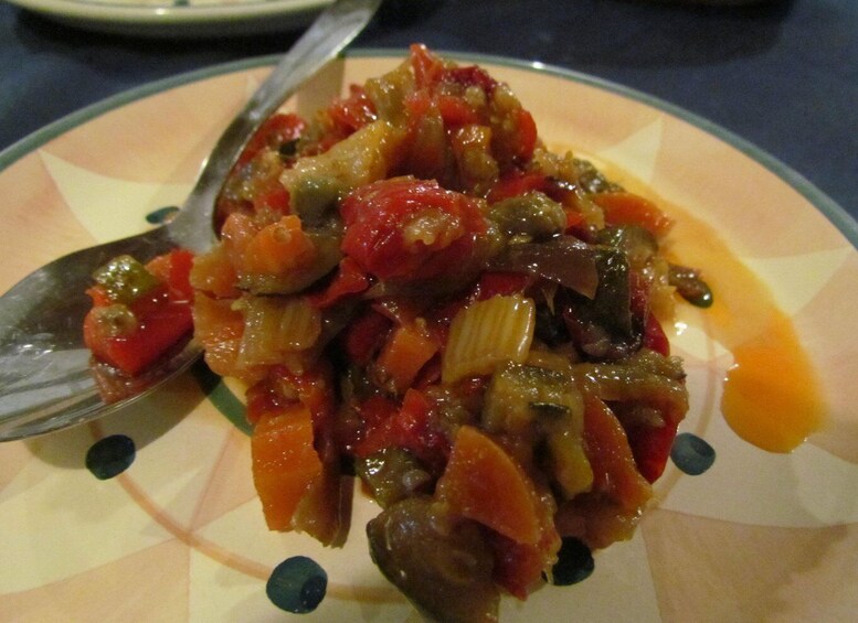 A plate of mixed vegetables with a fork on it. 2