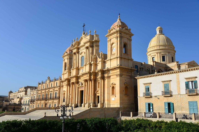 A historic church with a large dome and bell tower, surrounded by classic architecture. 1