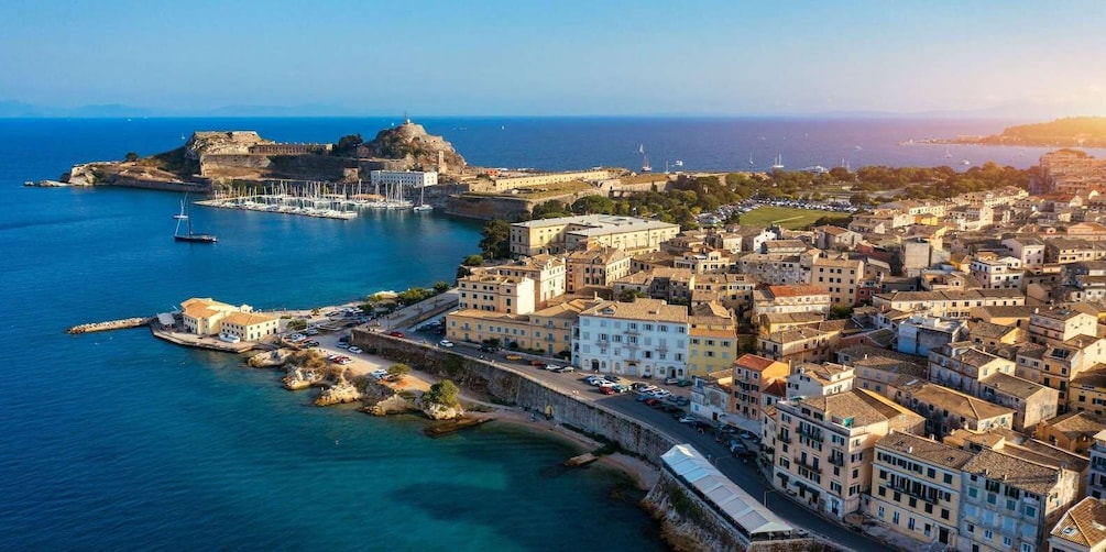 A coastal cityscape with a prominent fortress, marina, and dense urban architecture. 5