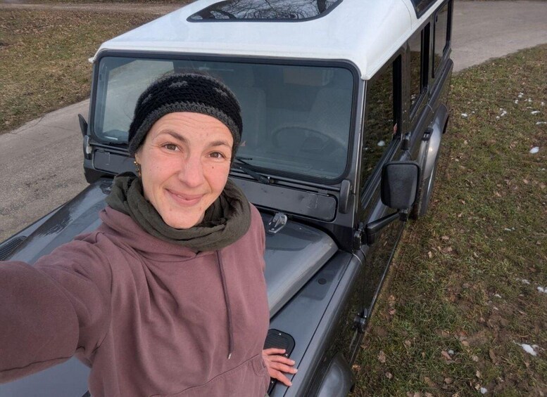 A person taking a selfie with a vehicle's open trunk. 1