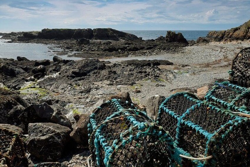 Rocky terrain with fishing nets and a coastal view. 3