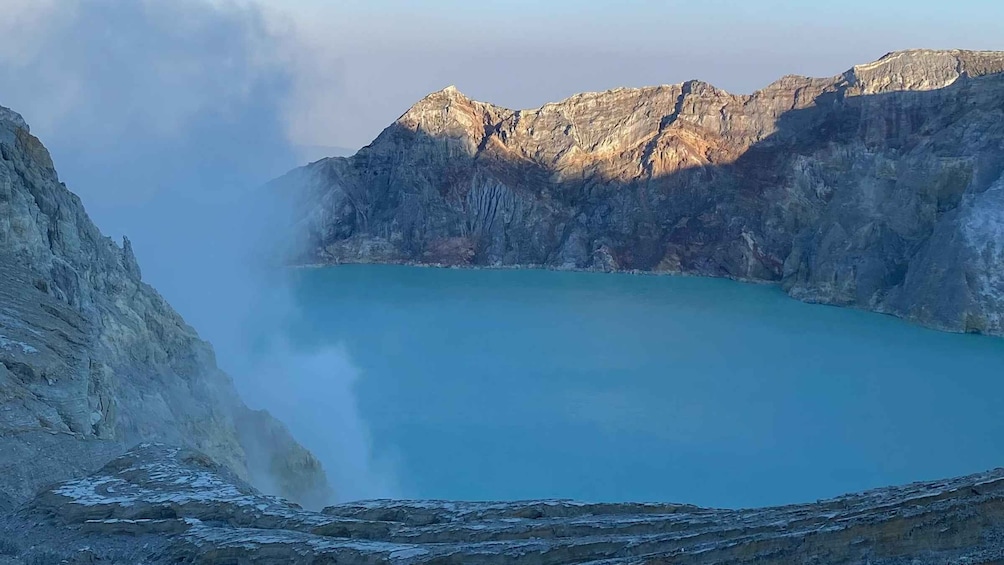 A mountain lake surrounded by rugged cliffs. 3