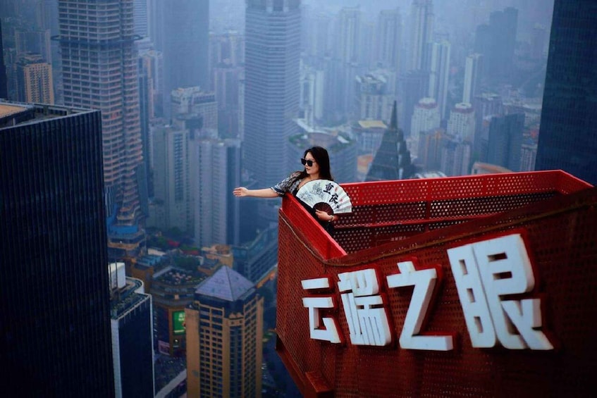 A person standing on a high-rise building with a cityscape in the background. 3