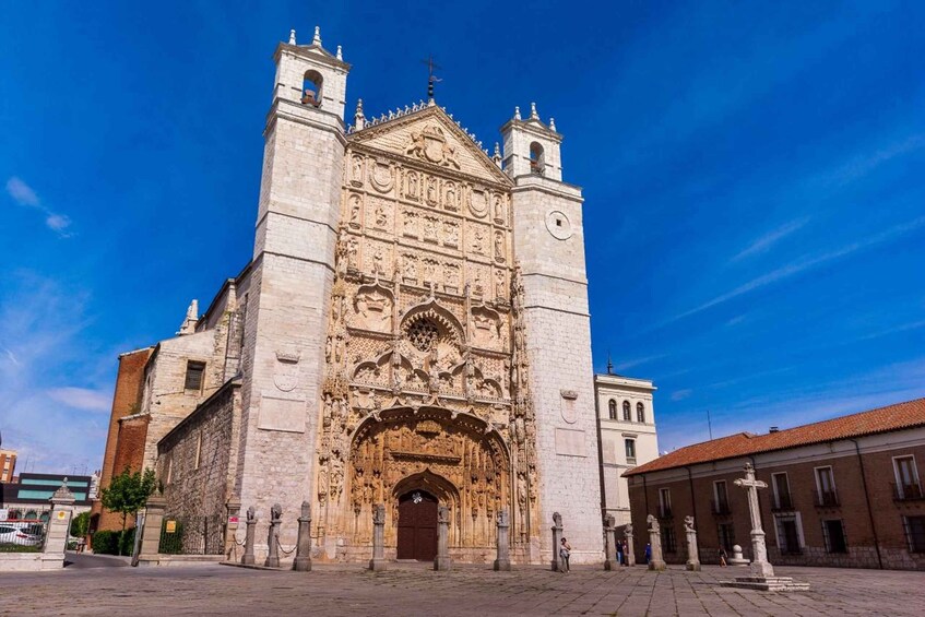 A historic cathedral with intricate facade carvings, two bell towers, and a large arched entrance. 1