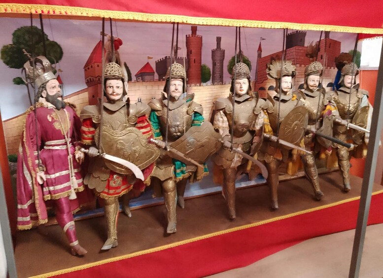A historical reenactment with figures in armor and a castle backdrop. 4