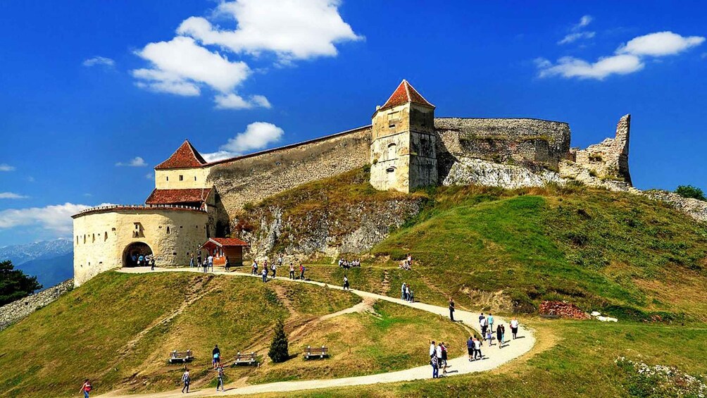 A historic castle on a hill with a clear sky. 4