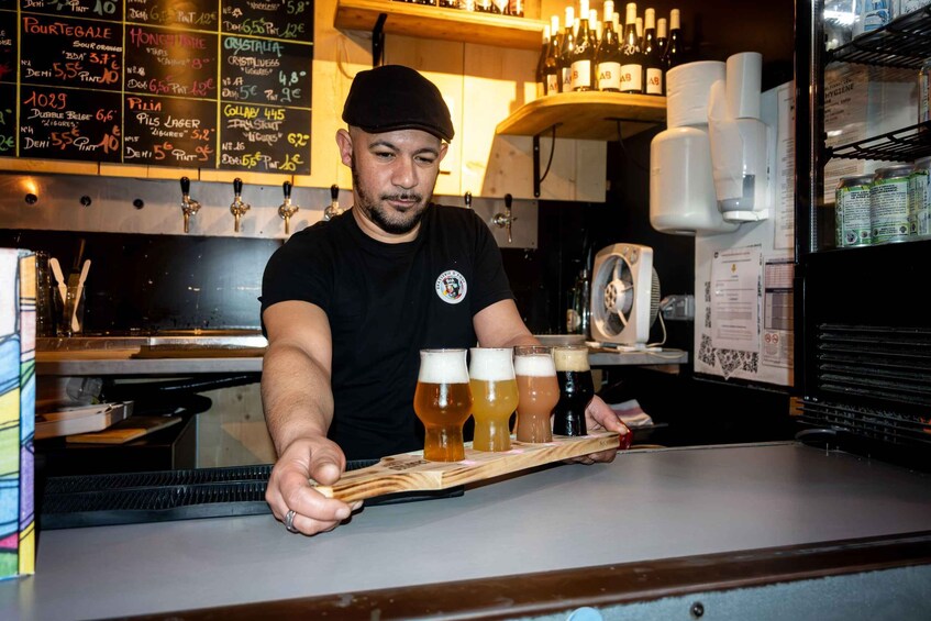 A bartender serving a flight of beers at a bar. 4