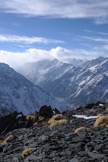 A mountainous landscape with snow-covered peaks and a rocky foreground. 4
