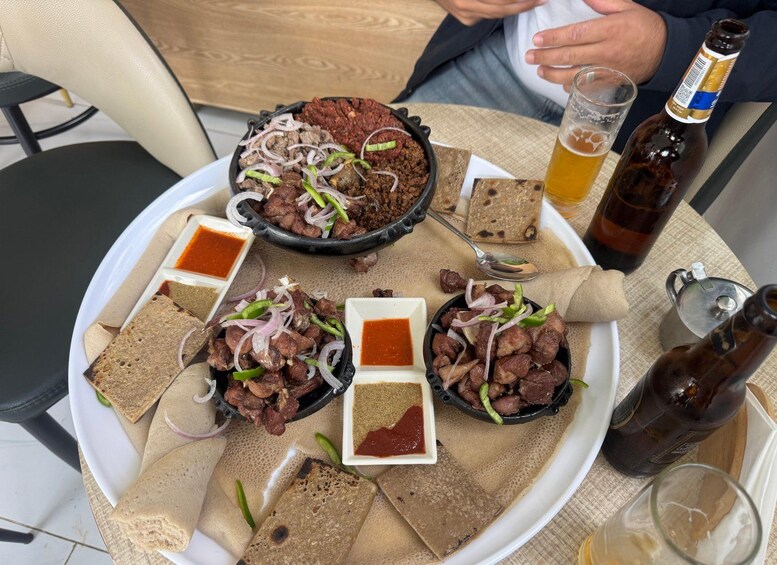 A meal with meat, bread, and drinks on a table. 1