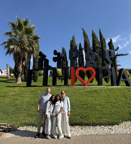 A family posing in front of a sign with 'Ethiopia' and a heart symbol. 2