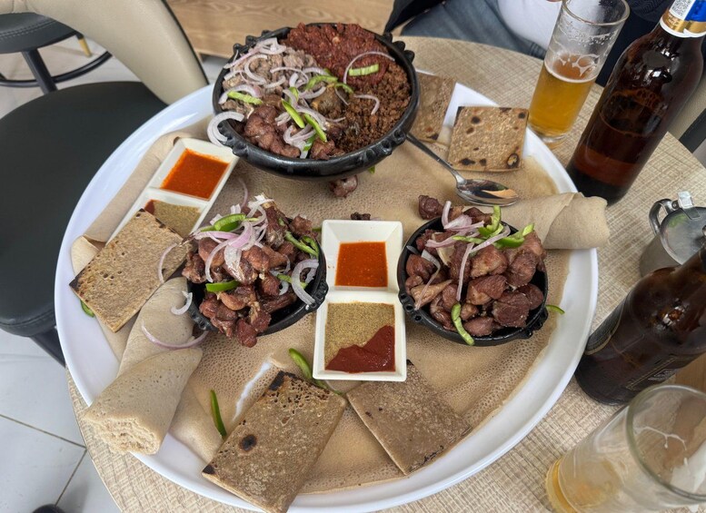 A meal with meat, flatbreads, and sauces on a plate. 3