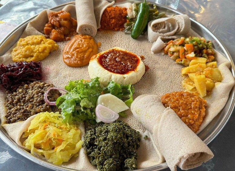 A traditional Ethiopian meal with injera, various stews, and salads. 4