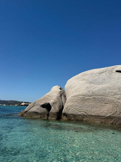 A clear blue sea with large rock formations. 3