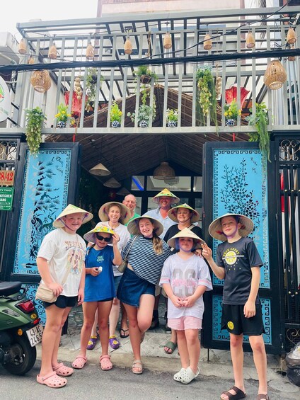 A group of people standing in front of a building with a decorative entrance. 5