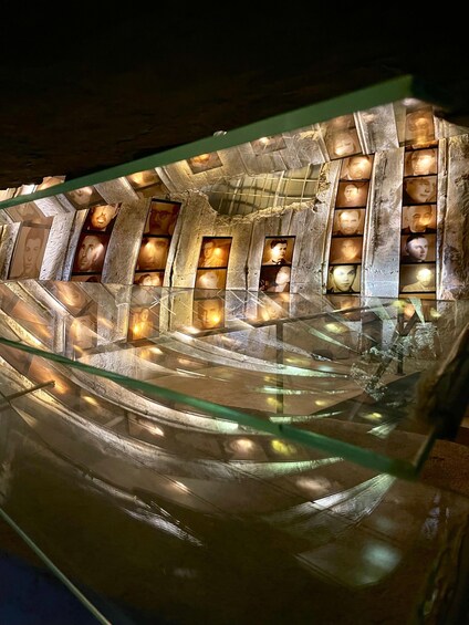 A spiral staircase with illuminated panels and a glass railing. 4