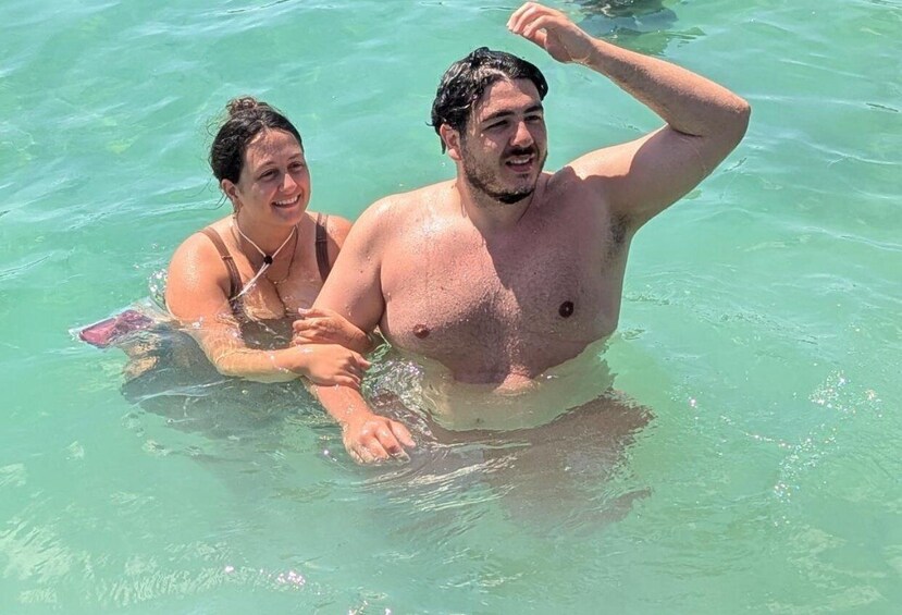 Two people swimming in clear turquoise water. 5