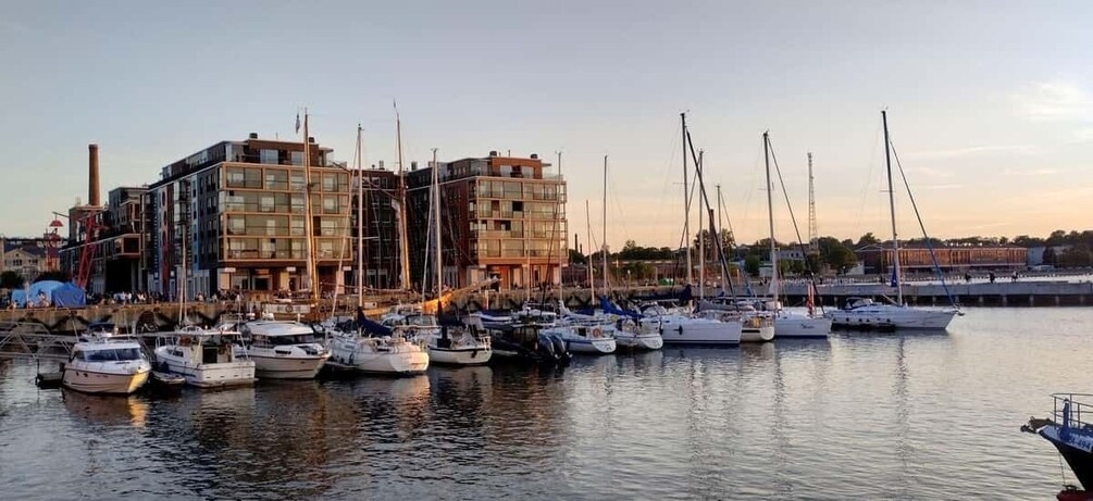 A marina with boats docked, a modern building, and a clear sky. 3