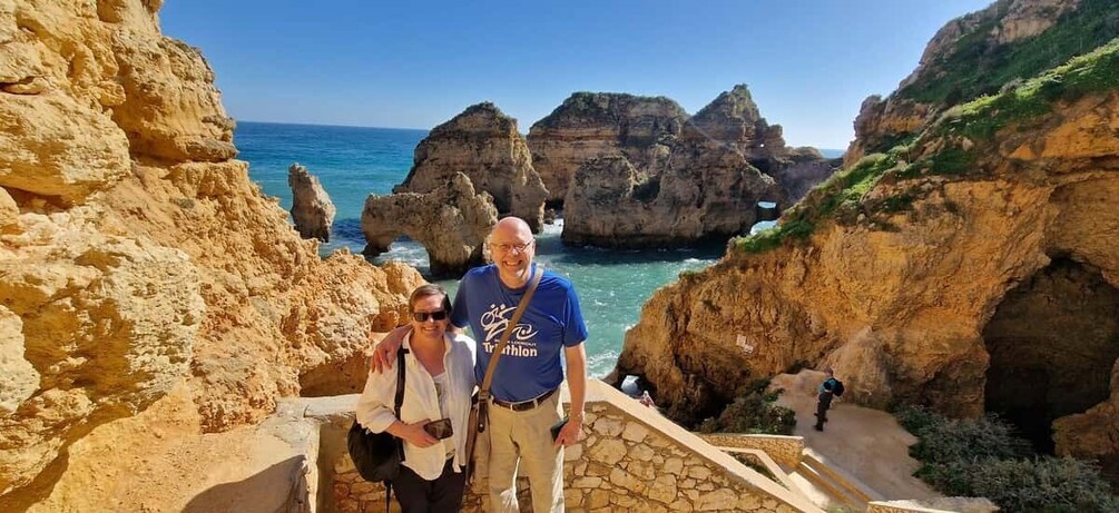 A coastal landscape with rocky cliffs and a clear blue sky. 3