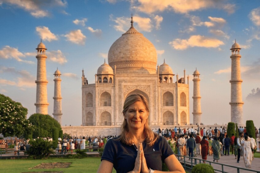 A person in front of the Taj Mahal with its four minarets and central dome. 4