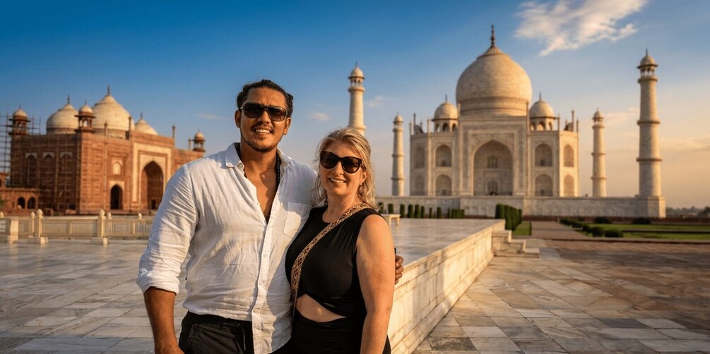 Two people standing in front of the Taj Mahal. 2