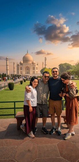 A group of people posing in front of the Taj Mahal with the monument in the background. 5