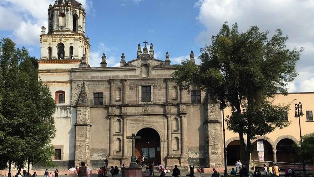A historic church with a bell tower and arched entrance. 3