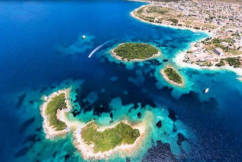 An aerial view of a coastal area with multiple small islands surrounded by clear blue waters. 2