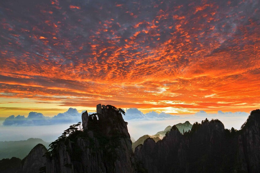 A mountainous landscape with a sunset sky. 2
