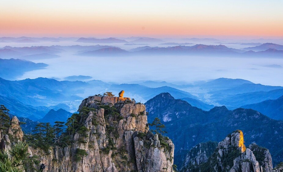 A mountain landscape with rocky outcrops and a clear sky. 5