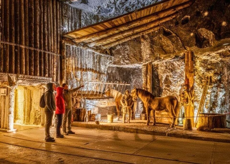 A nighttime scene with a wooden structure, a horse, and a person pointing. 5