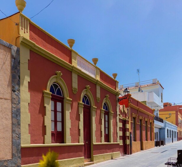 A street with colorful buildings, a clear blue sky, and a calm atmosphere. 5