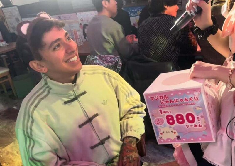 A person holding a pink box with Japanese text and a number 880 on it. 4