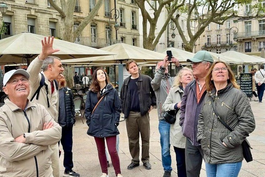 A group of people standing outdoors, some taking photos. 5