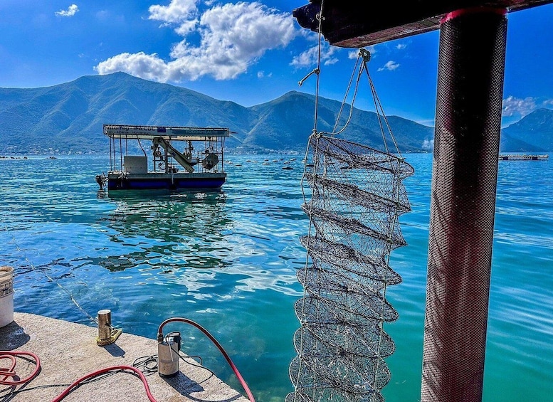 A fishing boat on calm waters with mountains in the background. 2