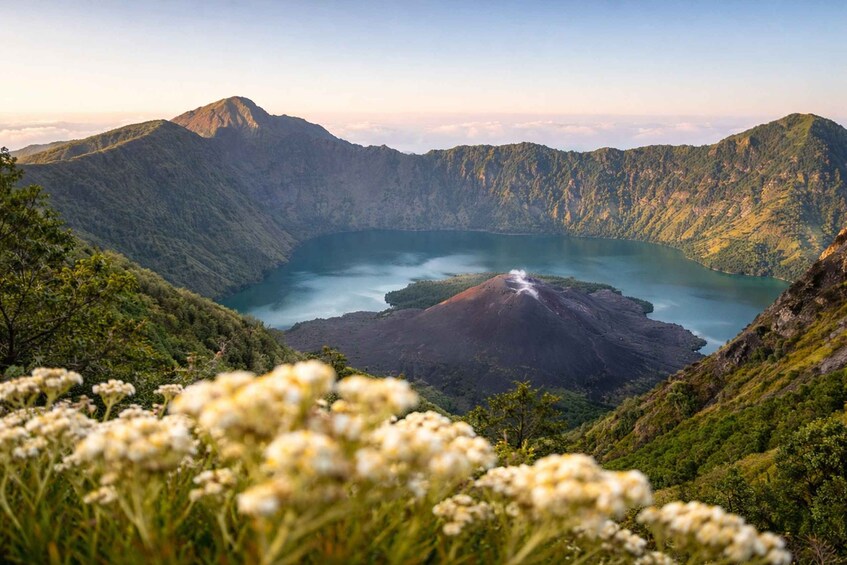 A volcanic crater lake surrounded by lush green mountains. 5