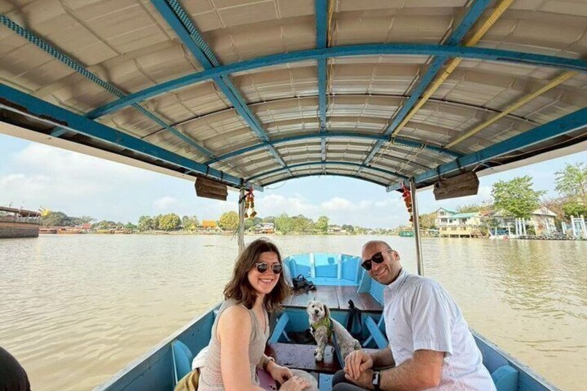 A boat with a covered roof, a dog, and a person wearing a white shirt. 5