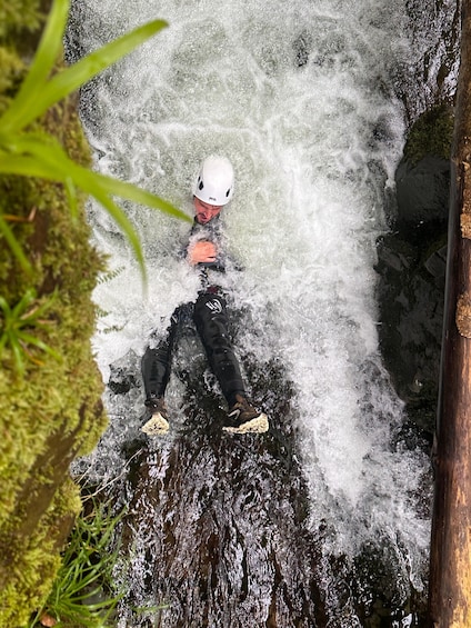 A person rappelling down a waterfall. 4
