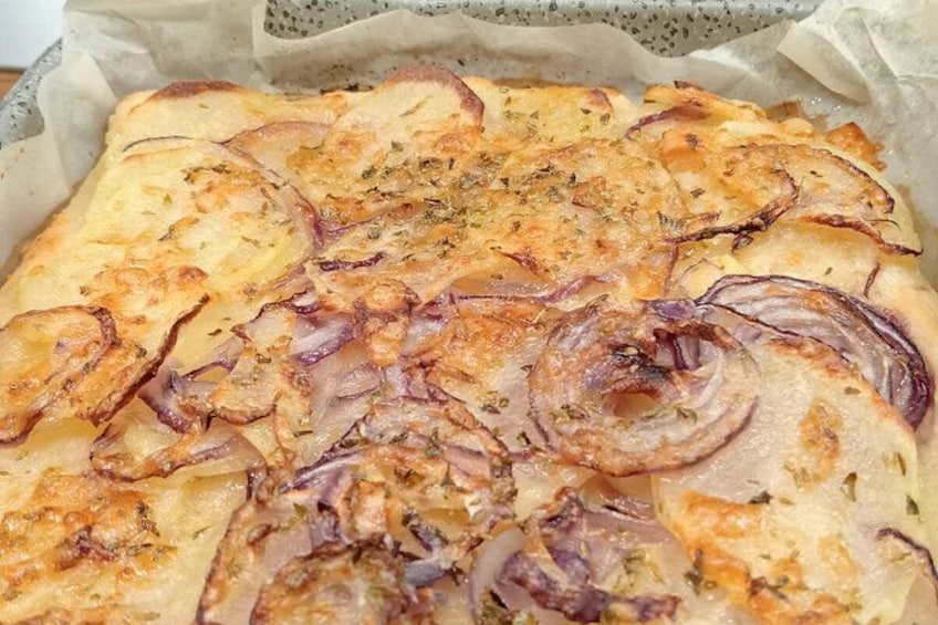 A baked dish with potatoes and onions. 2