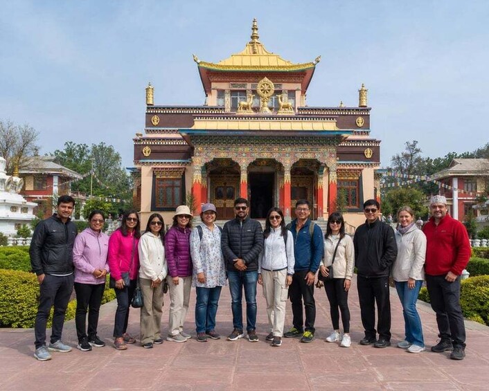 A group of people in front of a traditional building with ornate architecture. 2