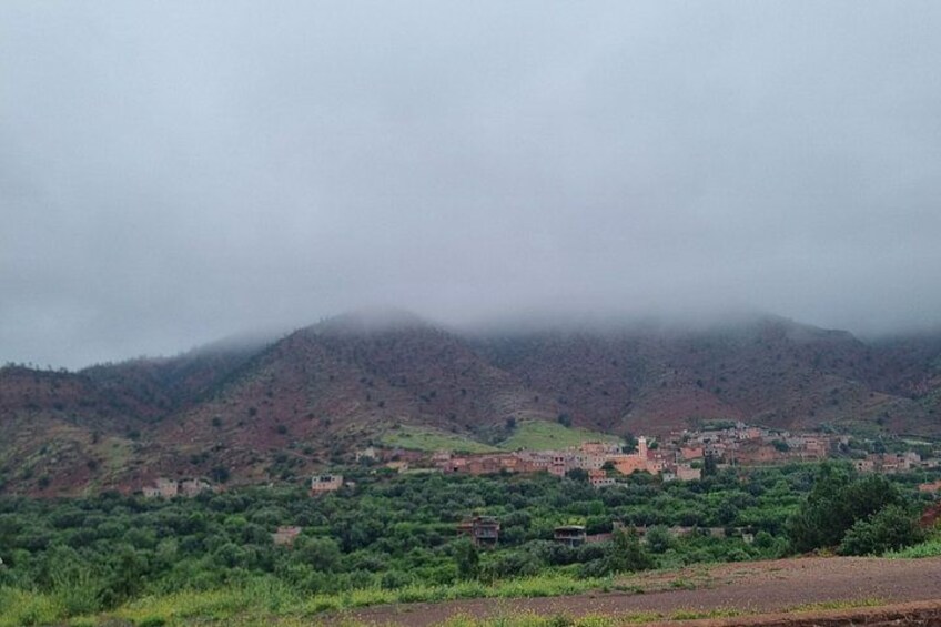 A mountainous landscape with a village nestled in the valley. 4