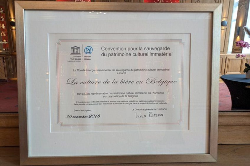 A framed certificate with text in French, signed by an individual, and dated 30 November 2016. 3