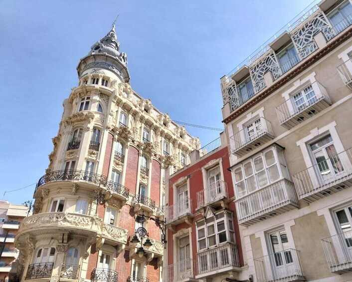 A historic building with ornate balconies and a tower. 3