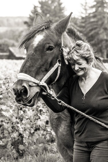 A person with a horse in a natural setting. 1