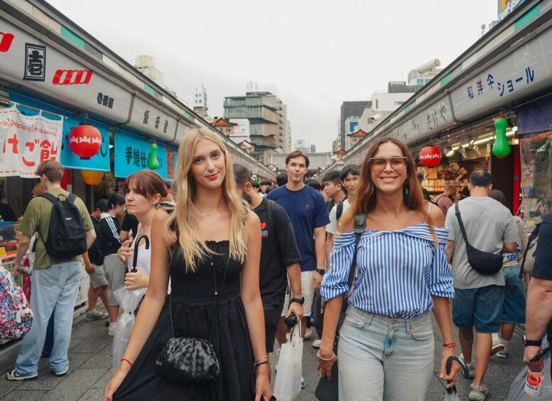 A crowded street with people walking, shops, and signs in a foreign language. 5