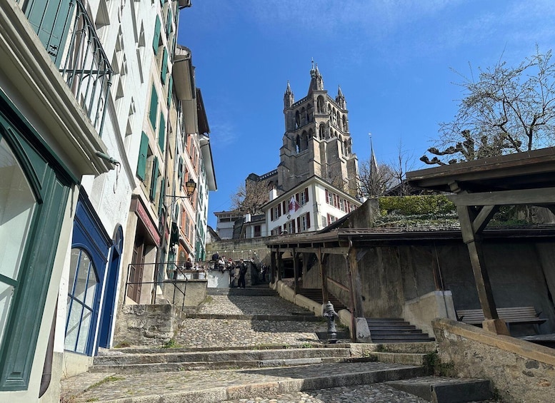 A historic town with stone steps leading to a church tower. 1