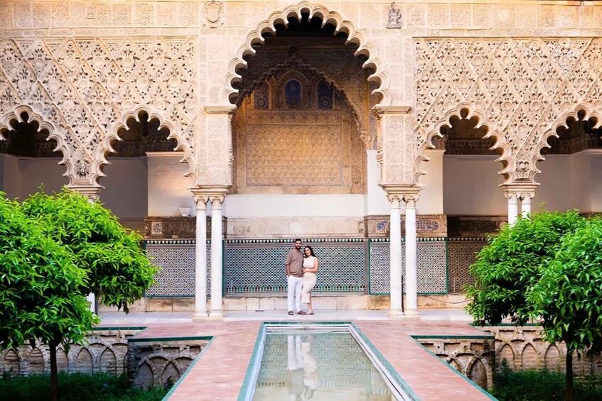 A courtyard with ornate arches, a central fountain, and lush greenery. 1