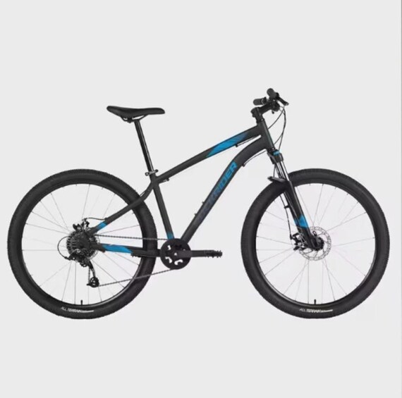 A black and blue mountain bike with a front suspension fork, disc brakes, and a chain drive. 4