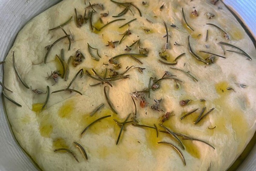 A flatbread topped with olive oil and rosemary. 4